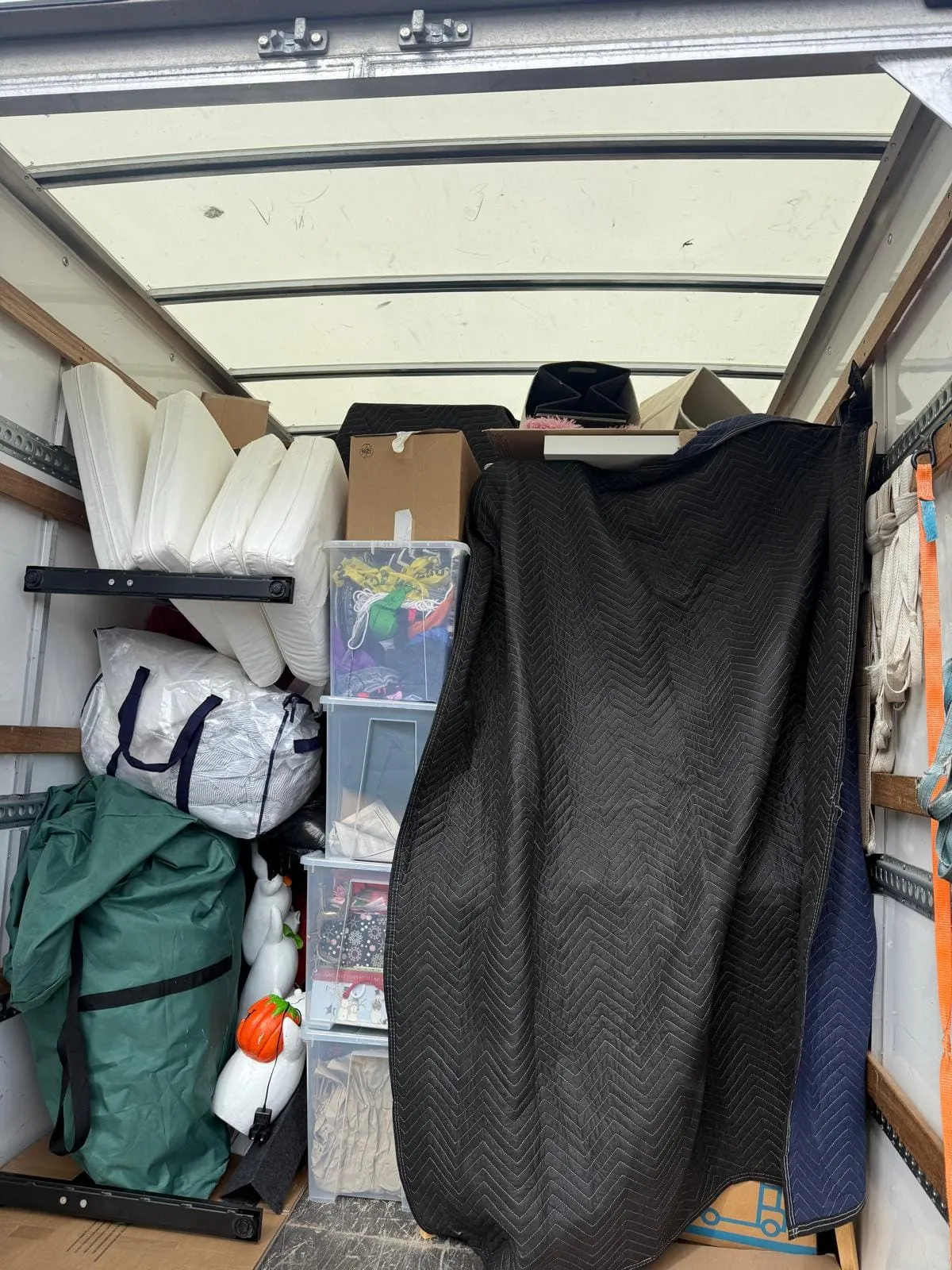 Kitchen packed into cardboard boxes with glasses wrapped for a move