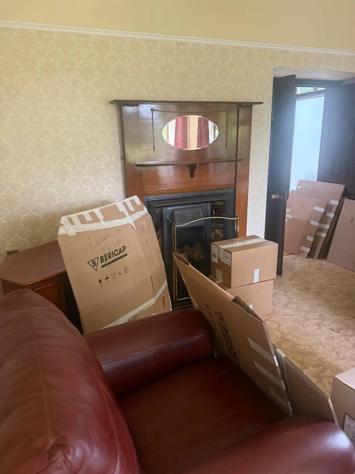Wardrobe and a suitcase being packed in a bedroom