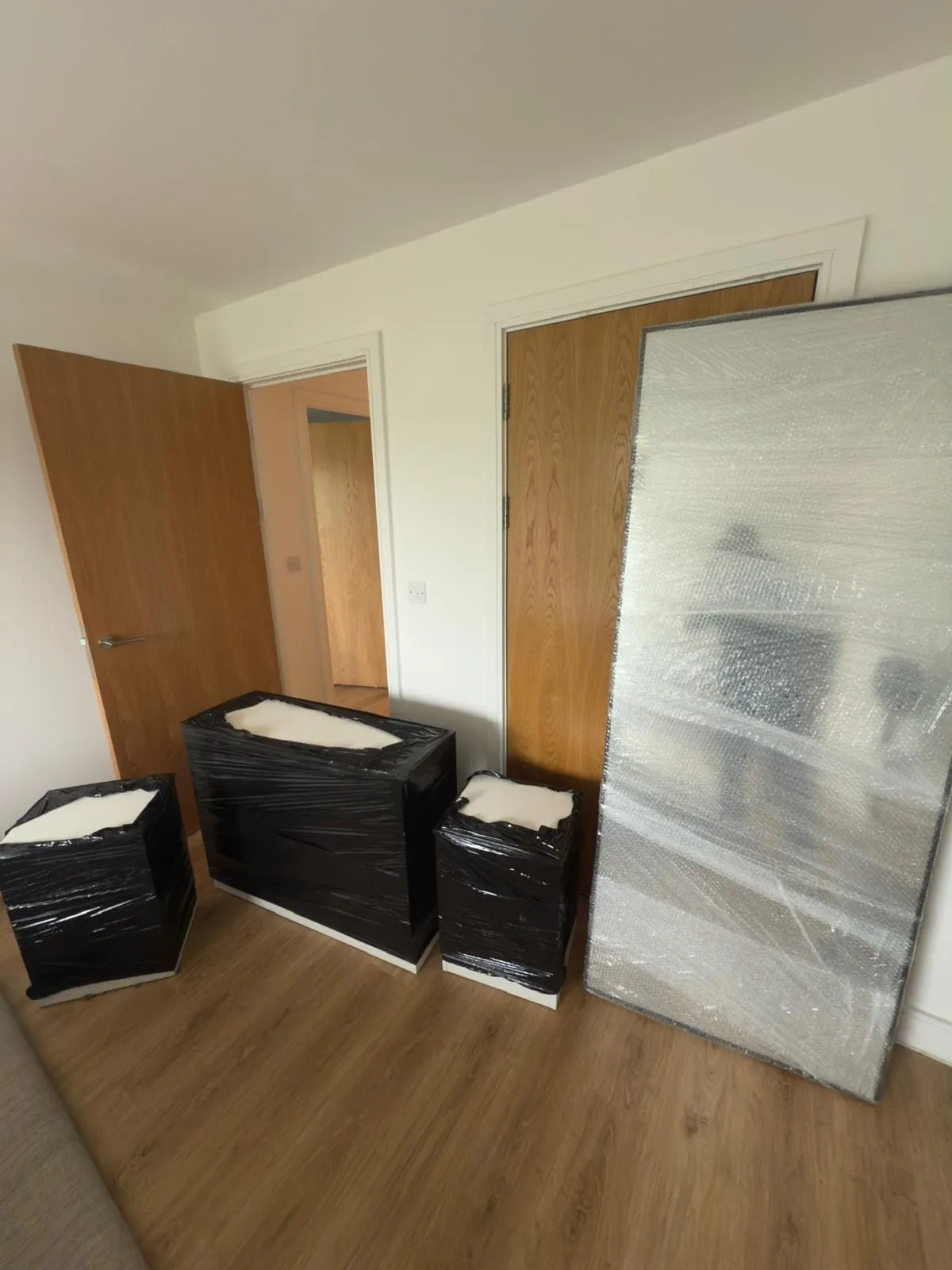 Boxes and a bicycle in a shared-house kitchen