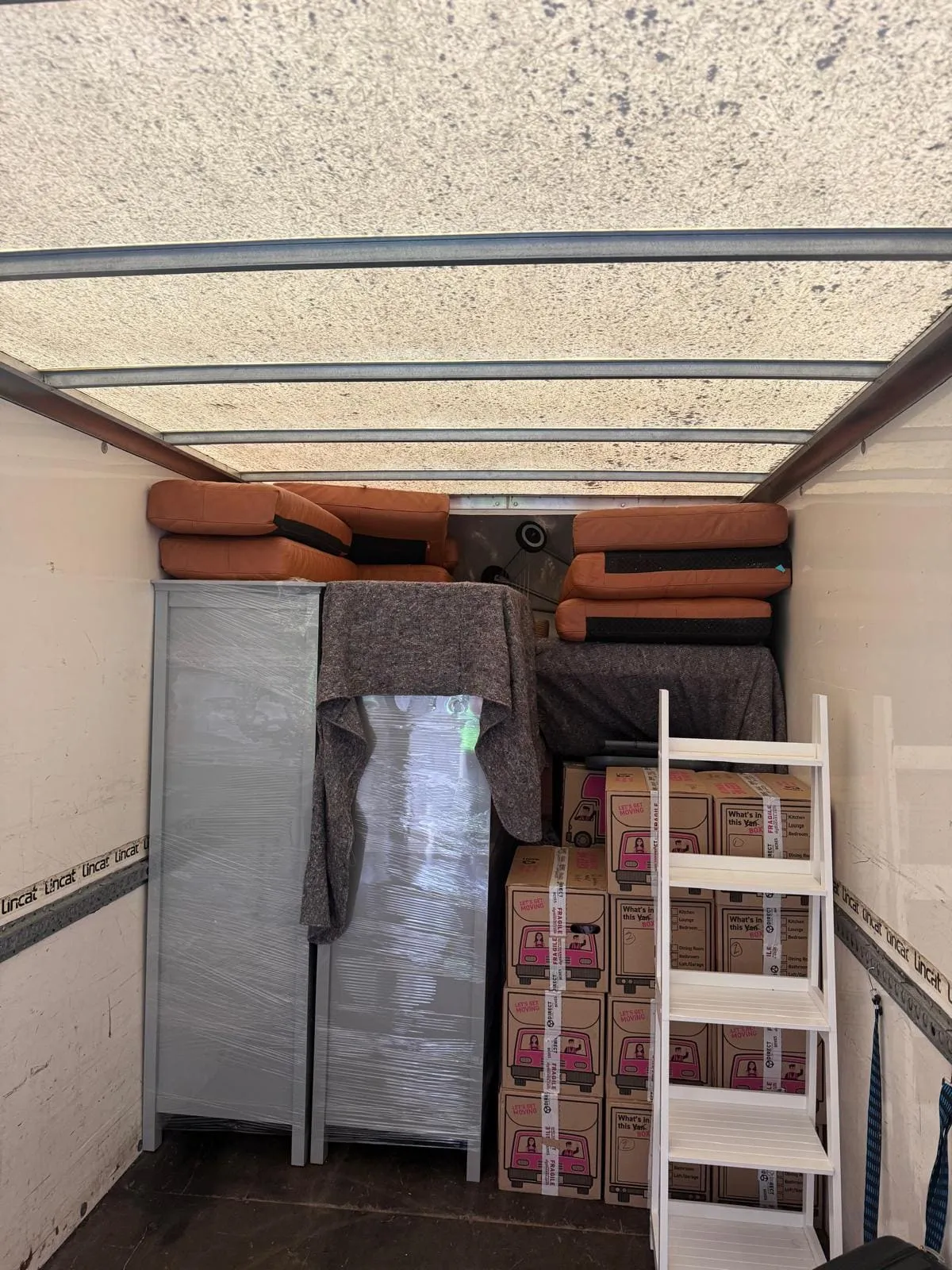 Luton box van parked on a narrow terraced street